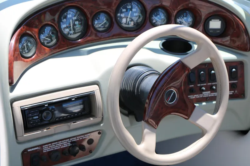 Slide: The Image of Dashboard of a 1996 Chaparral 2330 SS boat with gauges and steering wheel. - 32