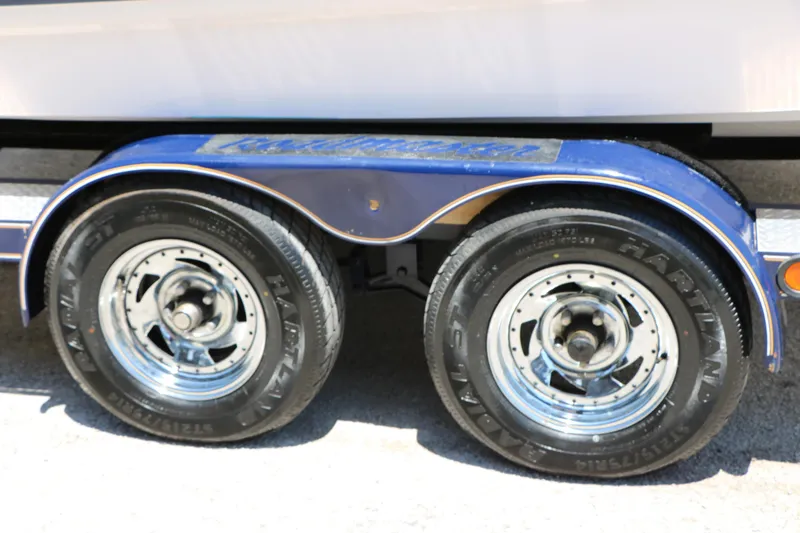 Slide: The Image of Trailer wheels of a 1996 Chaparral 2330 SS boat, featuring chrome rims and Hartland tires. - 40