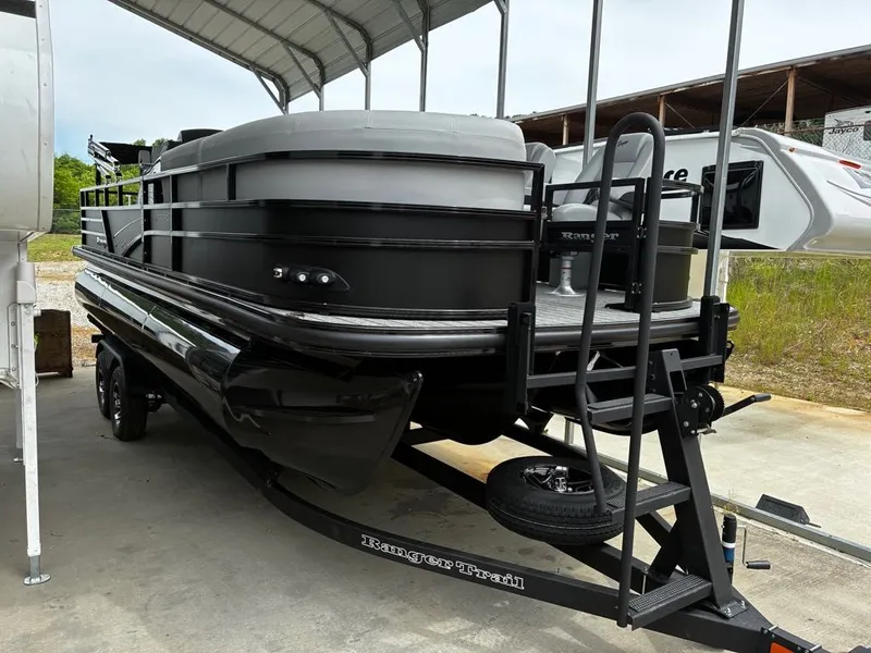 Slide: The Image of 2026 Ranger 223FC pontoon boat on trailer under cover. - 12