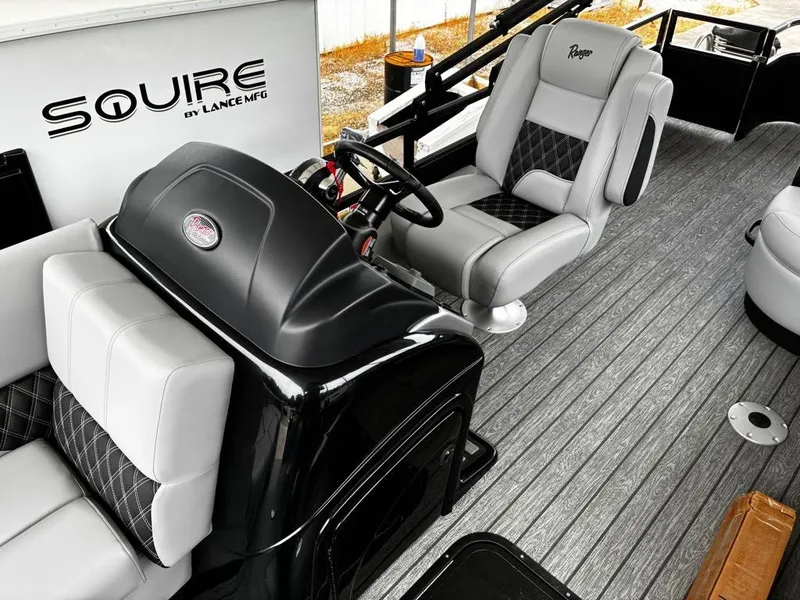 Slide: The Image of Interior of 2026 Ranger 223FC with gray seating and steering wheel. - 14