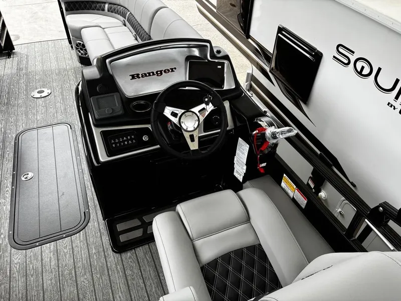 Slide: The Image of Interior of 2026 Ranger 223FC with steering wheel and seating area. - 8