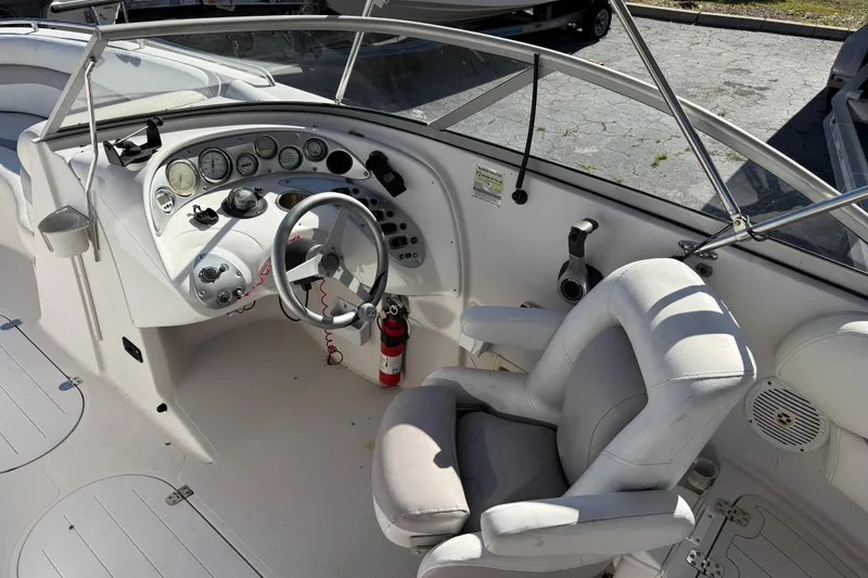 Slide: The Image of 2005 Starcraft Aurora 2210 OB boat cockpit with steering wheel and control panel. - 10