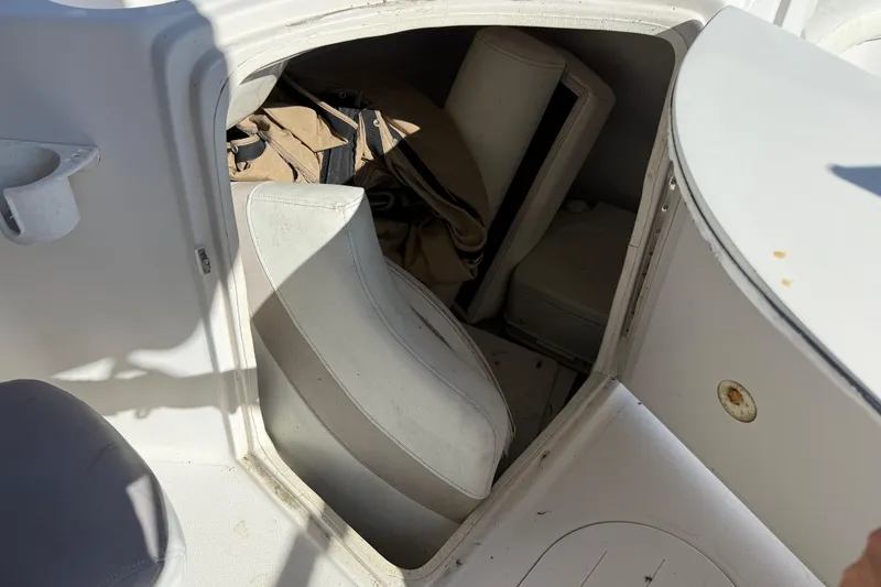 Slide: The Image of Interior storage area of a 2005 Starcraft Aurora 2210 OB boat with cushions and gear. - 12