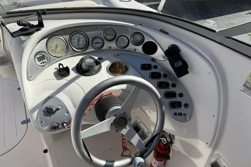 Slide: The Image of 2005 Starcraft Aurora 2210 OB boat dashboard with gauges and steering wheel. - 13