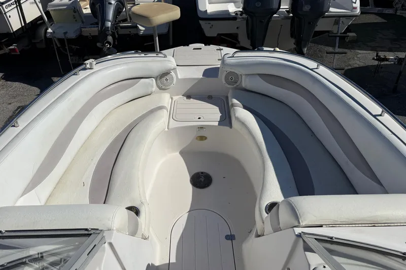 Slide: The Image of 2005 Starcraft Aurora 2210 OB boat interior with white seating and storage compartments. - 17