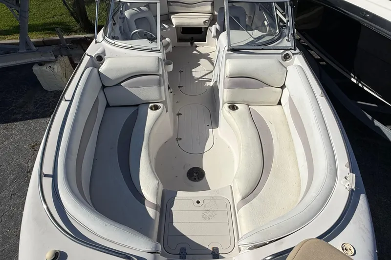 Slide: The Image of 2005 Starcraft Aurora 2210 OB boat interior with white seating and open deck layout. - 18