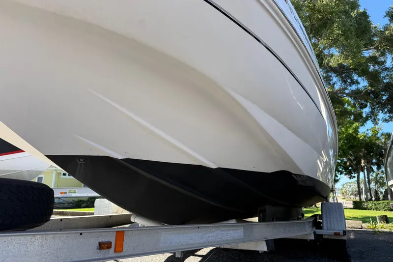 Slide: The Image of 2005 Starcraft Aurora 2210 OB boat on trailer, showcasing hull design and structure. - 2
