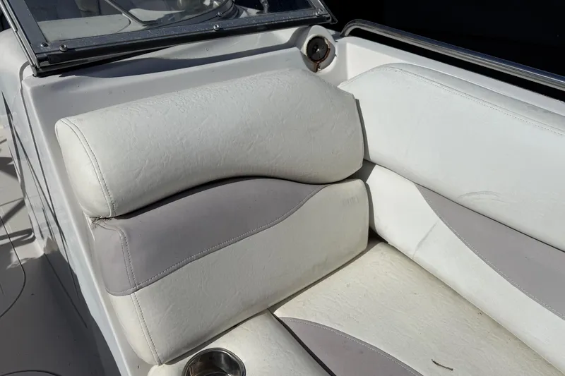 Slide: The Image of 2005 Starcraft Aurora 2210 OB boat interior with white and gray seating. - 20
