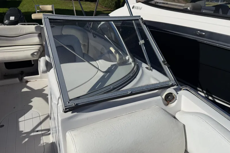 Slide: The Image of 2005 Starcraft Aurora 2210 OB boat interior with windshield and seating. - 24