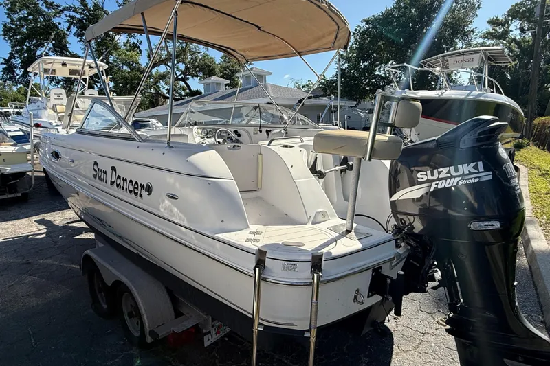 Slide: The Image of 2005 Starcraft Aurora 2210 OB boat with Suzuki outboard motor, parked on a trailer. - 5