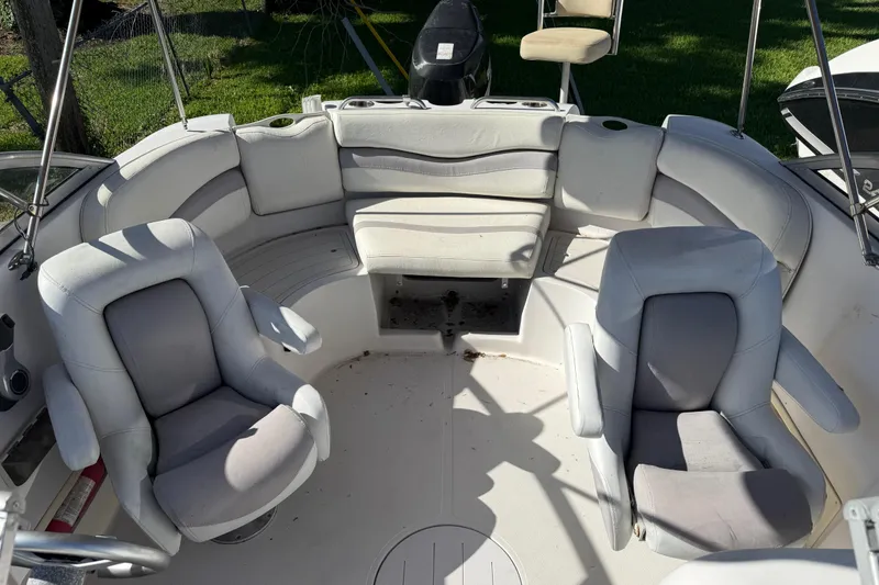 Slide: The Image of 2005 Starcraft Aurora 2210 OB boat interior with white seating and steering chairs. - 9
