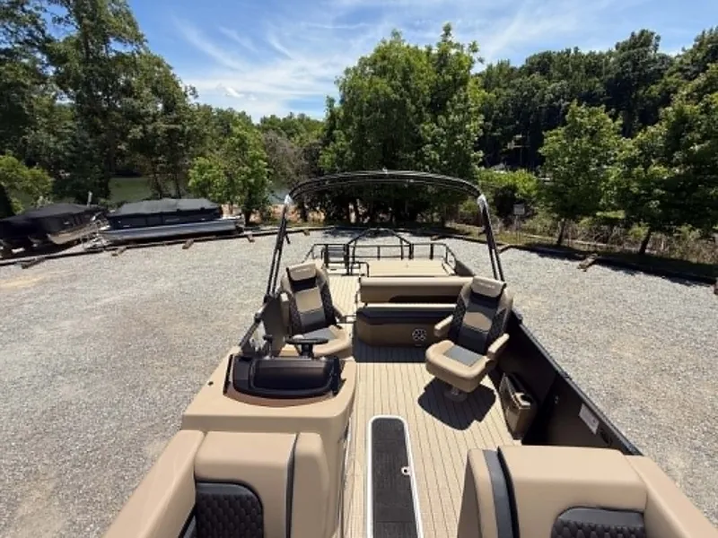 Slide: The Image of 2026 Sylvan L-3 DLZ Platnium pontoon boat on gravel lot. - 3