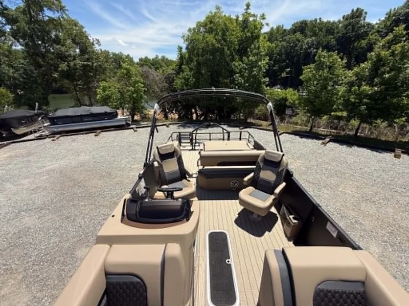 Slide: The Image of 2026 Sylvan L-3 DLZ Platnium pontoon boat on gravel lot. - 33