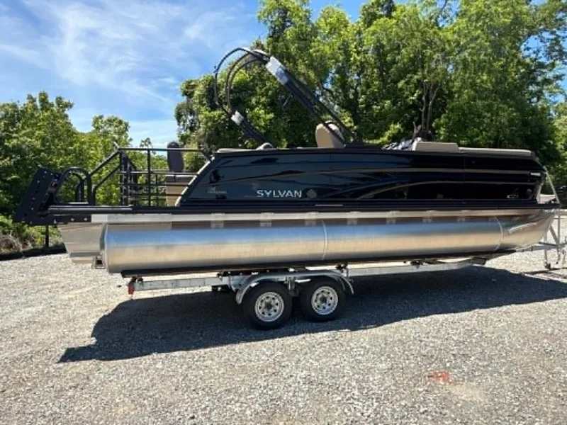 Slide: The Image of 2026 Sylvan L-3 DLZ Platnium pontoon boat on trailer outdoors. - 4