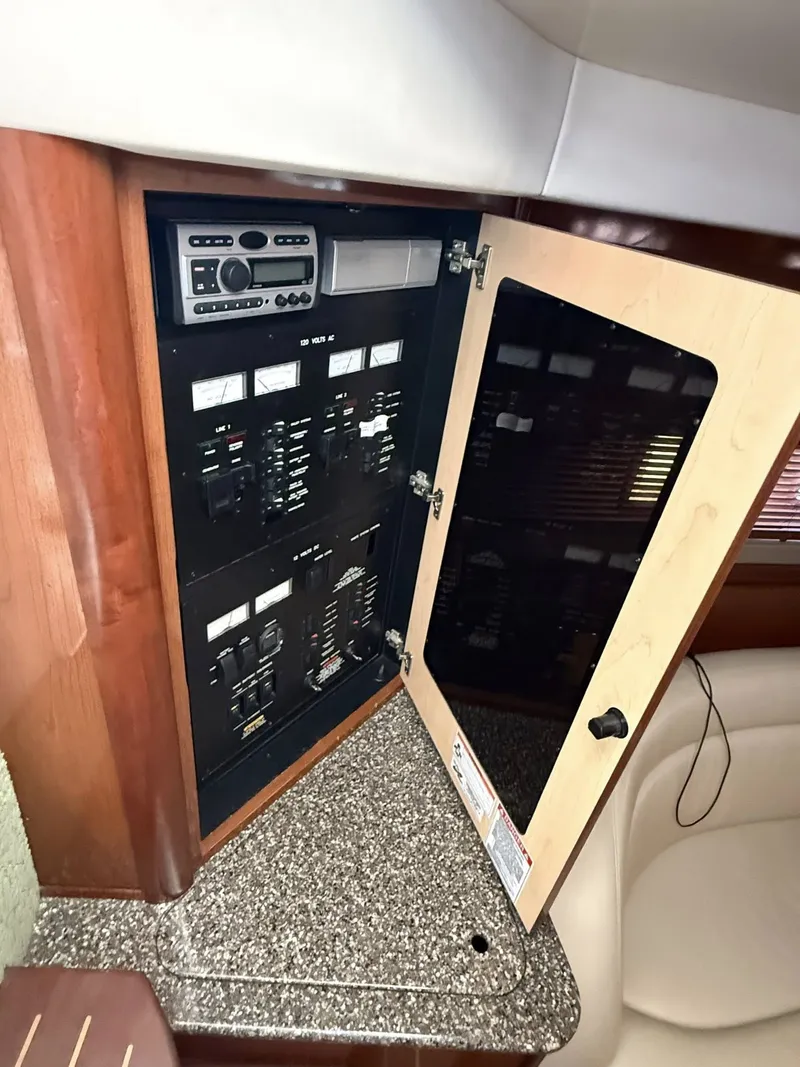 Slide: The Image of Electrical panel of 2008 Sea Ray 44 Sundancer with open door. - 24