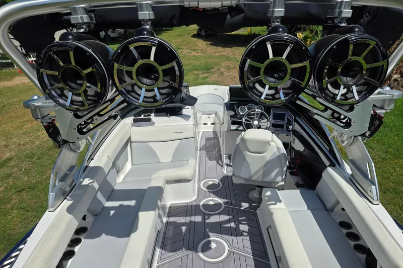 Slide: The Image of 2019 MasterCraft XT23 boat interior with premium seating and advanced audio system. - 10