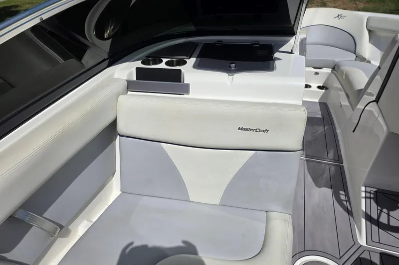 Slide: The Image of 2019 MasterCraft XT23 boat interior with white seating and sleek design. - 15