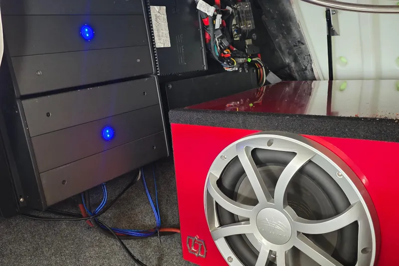 Slide: The Image of 2019 MasterCraft XT23 audio system with subwoofer and amplifiers, featuring blue LED lights. - 17