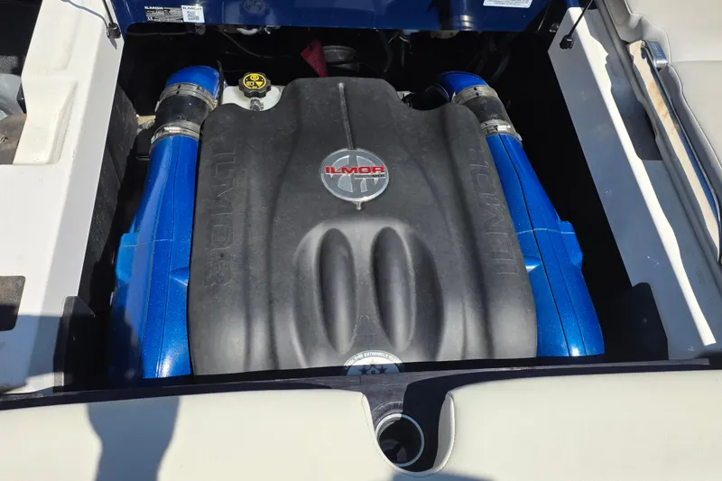 Slide: The Image of 2019 MasterCraft XT23 Ilmor engine with blue accents in boat compartment. - 20