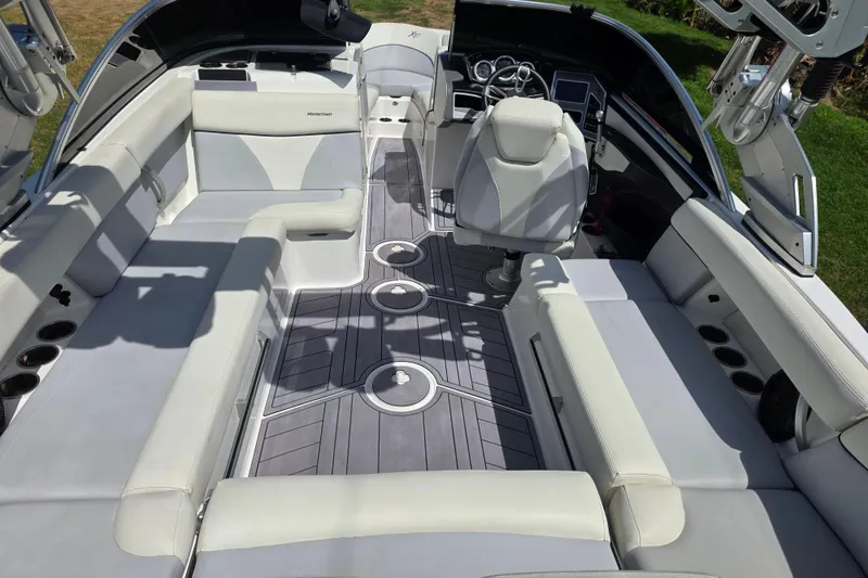 Slide: The Image of 2019 MasterCraft XT23 boat interior with spacious seating and modern dashboard. - 9
