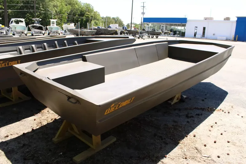 Slide: The Image of 2026 WeldBilt 1652V aluminum boat on a parking lot. - 5