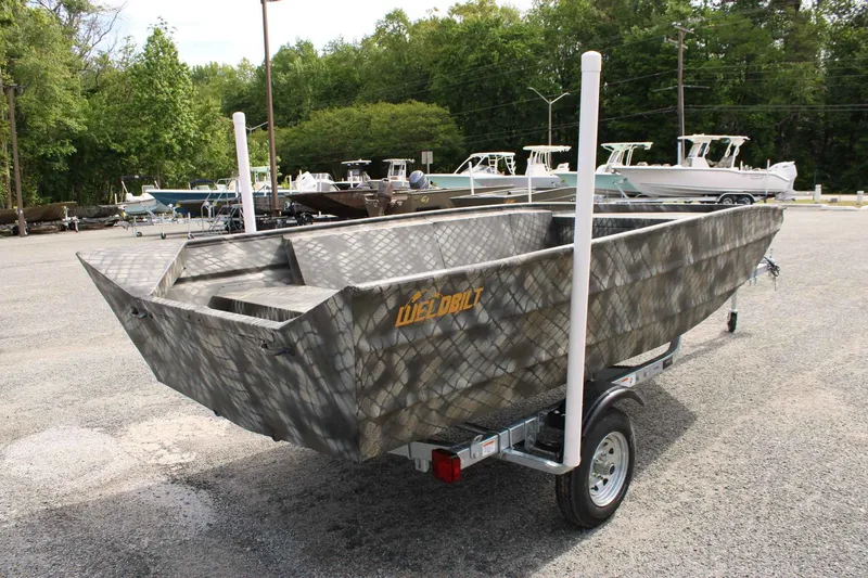 Slide: The Image of 2026 WeldBilt 1660V boat on trailer outdoors. - 10