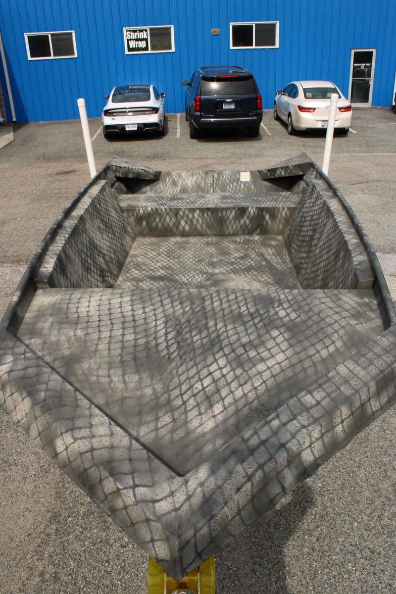 Slide: The Image of WeldBilt 1660V boat 2026 parked in front of blue building. - 11