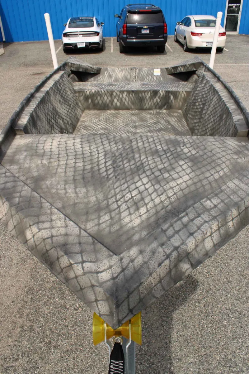 Slide: The Image of 2026 WeldBilt 1660V boat with camouflage pattern on parking lot. - 12