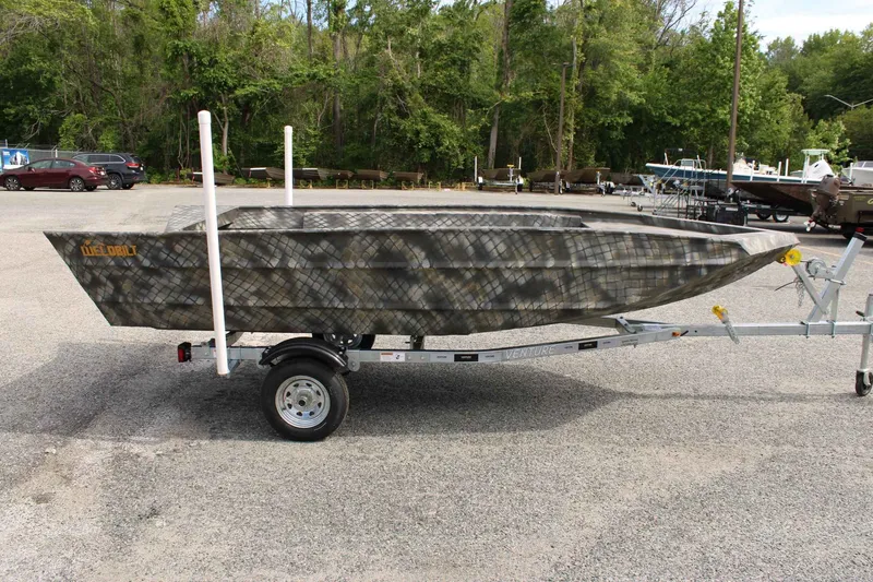 Slide: The Image of 2026 WeldBilt 1660V boat parked on trailer outdoors. - 4