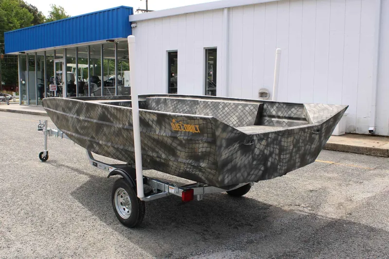 Slide: The Image of 2026 WeldBilt 1660V boat on trailer outside a store. - 8