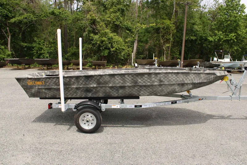 Slide: The Image of 2026 WeldBilt 1552V boat on trailer parked outdoors. - 6