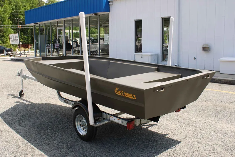 Slide: The Image of WeldBilt 1448V 2026 boat on trailer outside a building. - 6