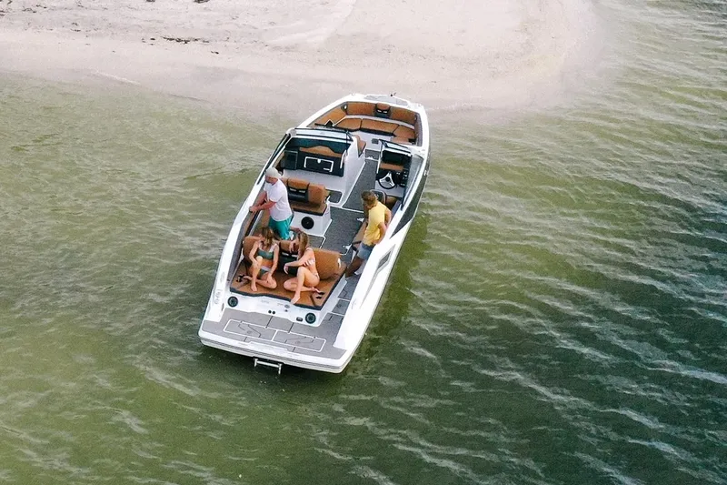 Slide: The Image of Aerial view of a 2021 Scarab 285 ID boat near the shore. - 11
