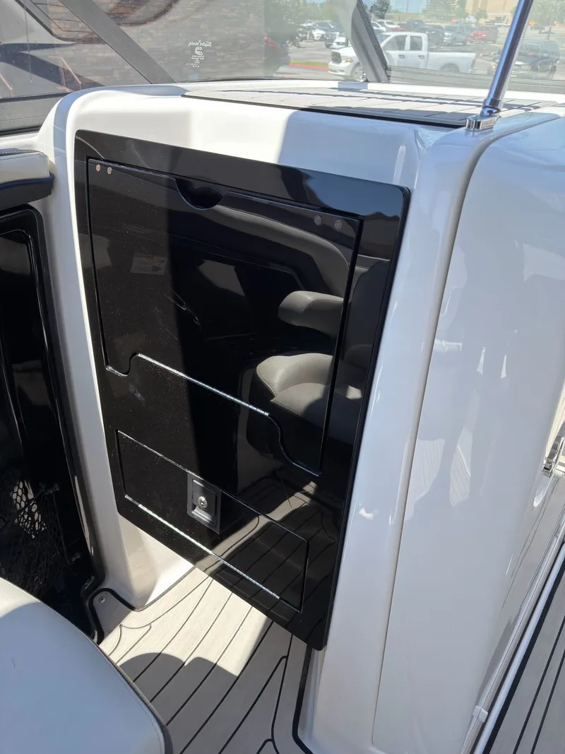 Slide: The Image of Interior of 2020 Yamaha Boats 242S with black cabinet. - 23