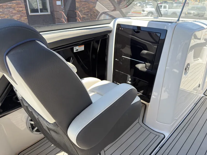 Slide: The Image of Interior of a 2020 Yamaha Boats 242S with seat and helm console. - 29