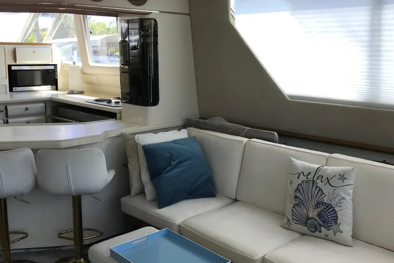 Slide: The Image of Luxurious interior of 1995 Sea Ray 550 Sedan Bridge yacht with cozy seating and modern kitchen. - 11