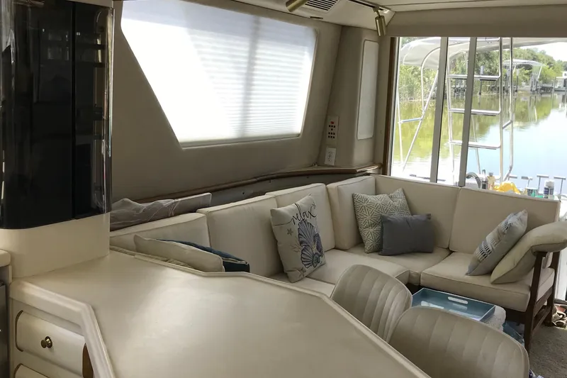 Slide: The Image of Luxurious interior of a 1995 Sea Ray 550 Sedan Bridge yacht with plush seating and scenic views. - 13