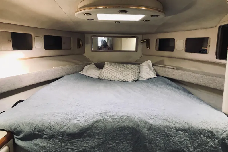 Slide: The Image of Cozy cabin interior of 1995 Sea Ray 550 Sedan Bridge yacht with bed and pillows. - 20