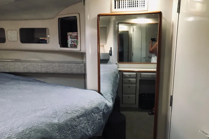 Slide: The Image of Interior cabin of a 1995 Sea Ray 550 Sedan Bridge with bed and mirror. - 22