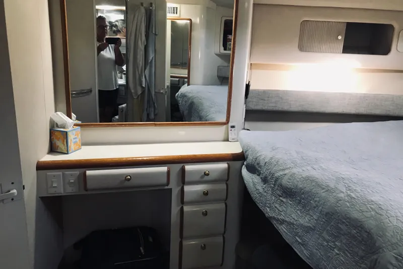 Slide: The Image of Interior cabin of a 1995 Sea Ray 550 Sedan Bridge yacht with bed and mirror. - 23