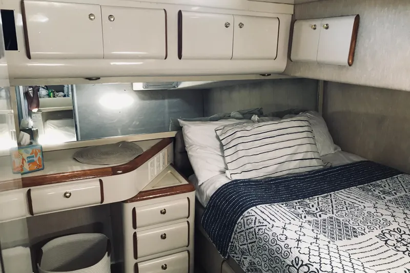Slide: The Image of Cozy cabin interior of 1995 Sea Ray 550 Sedan Bridge with bed and storage cabinets. - 24
