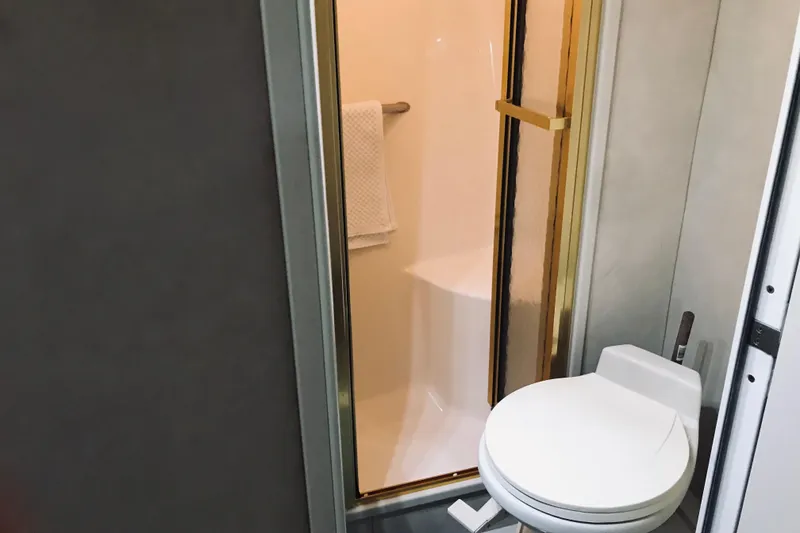 Slide: The Image of Bathroom interior of 1995 Sea Ray 550 Sedan Bridge yacht with shower and toilet. - 28
