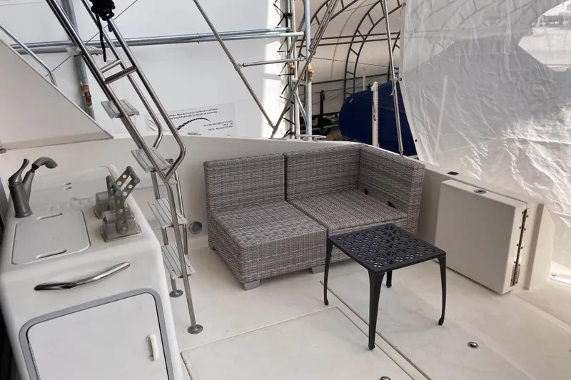 Slide: The Image of 1995 Sea Ray 550 Sedan Bridge yacht interior with seating area and kitchenette. - 7