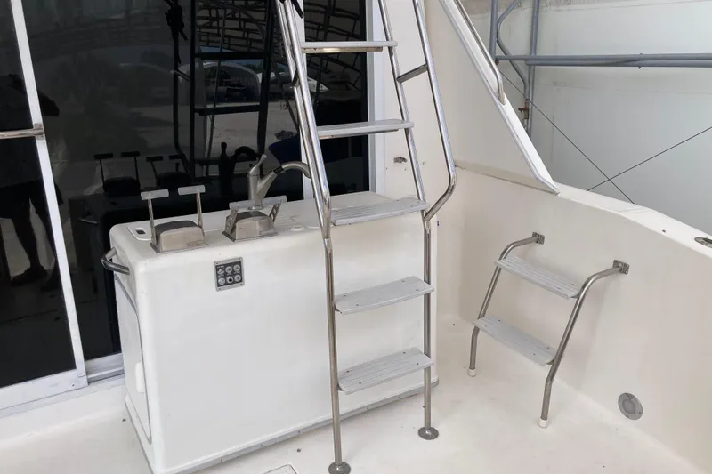 Slide: The Image of 1995 Sea Ray 550 Sedan Bridge yacht interior with stainless steel ladder and control panel. - 9