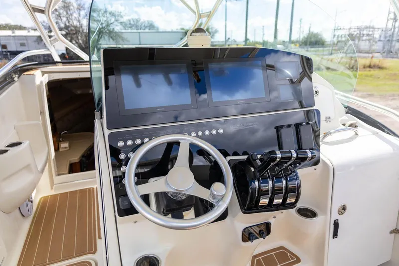 Slide: The Image of 2006 Hydra-Sports Vector 3300 VX helm with steering wheel and dual screens. - 12