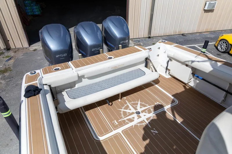 Slide: The Image of 2006 Hydra-Sports Vector 3300 VX boat with triple 250 horsepower engines and compass design flooring. - 13