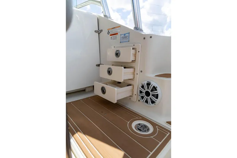 Slide: The Image of 2006 Hydra-Sports Vector 3300 VX interior with storage drawers and speaker. - 18