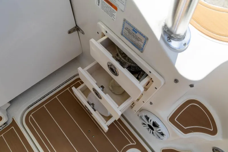 Slide: The Image of 2006 Hydra-Sports Vector 3300 VX boat interior with open storage drawers and speaker. - 19