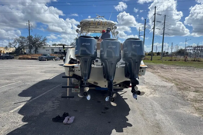 Slide: The Image of 2006 Hydra-Sports Vector 3300 VX boat with triple Yamaha 250 engines in a parking lot. - 2