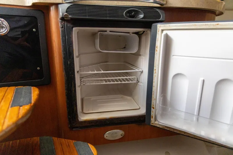 Slide: The Image of Open refrigerator inside a 2006 Hydra-Sports Vector 3300 VX boat cabin. - 26